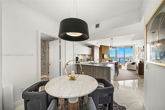 2900 NE 7th Ave Unit 2303, Miami, FL 33137 - dining space featuring baseboards and light marble finish floors