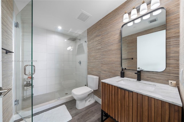 2900 NE 7th Ave Unit 2303, Miami, FL 33137 - full bathroom with tile walls, vanity, a shower stall, and wood finished floors