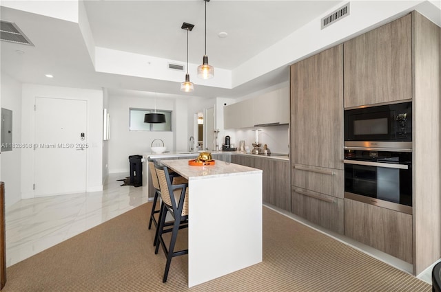 2900 NE 7th Ave Unit 2303, Miami, FL 33137 - kitchen with oven, built in microwave, modern cabinets, a breakfast bar, and a tray ceiling