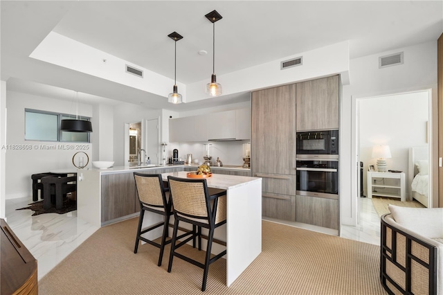 2900 NE 7th Ave Unit 2303, Miami, FL 33137 - kitchen with oven, modern cabinets, black microwave, and light countertops