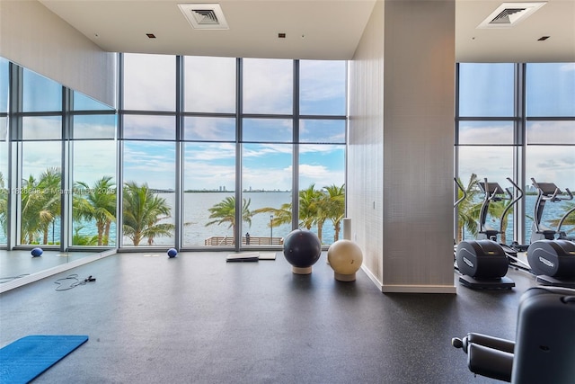 2900 NE 7th Ave Unit 2303, Miami, FL 33137 - workout area with floor to ceiling windows, a water view, and a towering ceiling