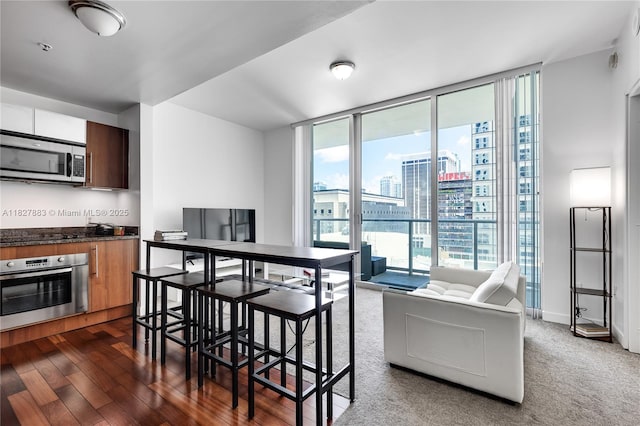 300 S Biscayne Blvd Unit T-1403, Miami, FL 33131 - dining area featuring a wall of windows, a city view, and dark wood finished floors