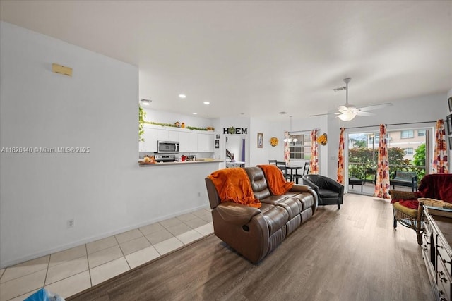 20025 Lake Vista Cir Unit 6B, Lehigh Acres, FL 33936 - living room with a ceiling fan, wood finished floors, and recessed lighting