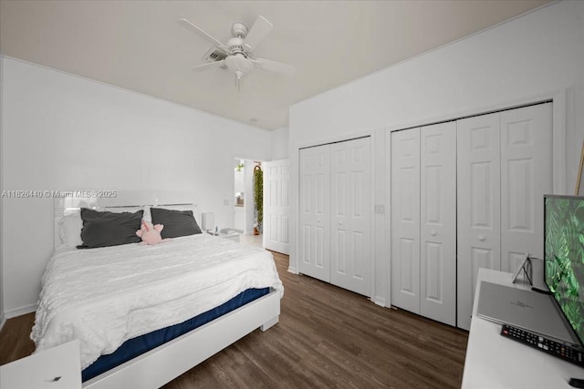 20025 Lake Vista Cir Unit 6B, Lehigh Acres, FL 33936 - bedroom with two closets, dark wood-style floors, and a ceiling fan