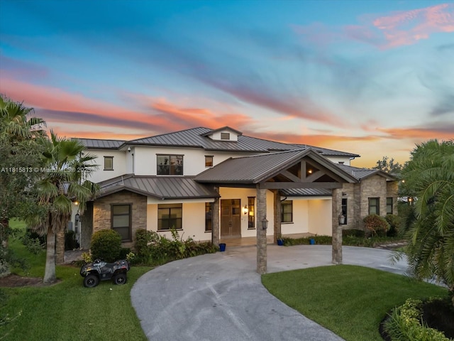 16675 C 24 Canal Rd, Port St Lucie, FL 34987 - view of front facade with a standing seam roof, stone siding, a metal roof, and a front lawn