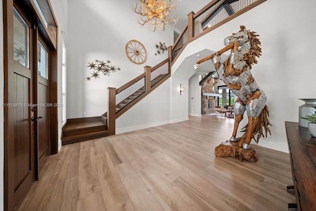 16675 C 24 Canal Rd, Port St Lucie, FL 34987 - foyer entrance with stairway, a towering ceiling, a chandelier, and wood finished floors