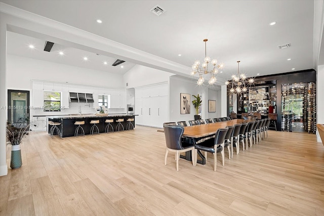 16675 C 24 Canal Rd, Port St Lucie, FL 34987 - dining area with a chandelier, light wood-style flooring, and recessed lighting