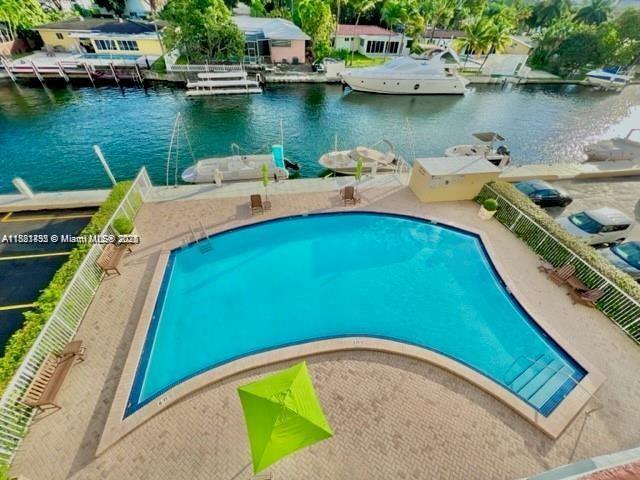 2020 NE 135th St Unit 407, North Miami, FL 33181 - community pool featuring a water view and a patio area