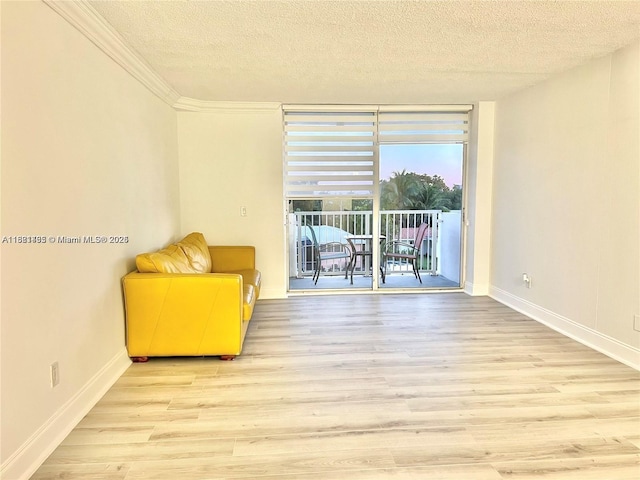 2020 NE 135th St Unit 407, North Miami, FL 33181 - sitting room featuring a textured ceiling, wood finished floors, and crown molding