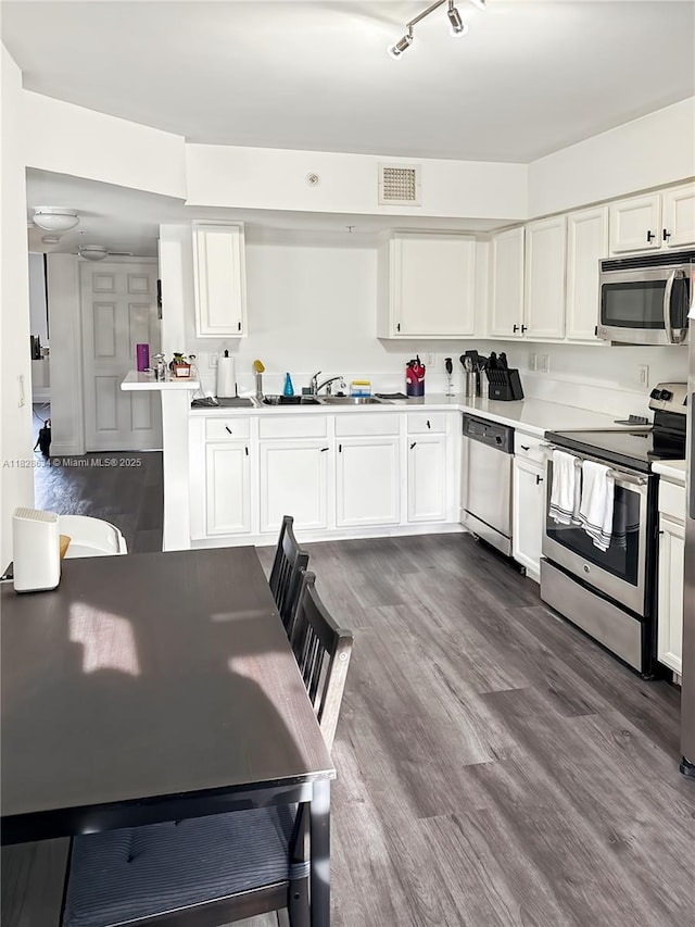 22551 SW 88th Pl Unit 205, Cutler Bay, FL 33190 - kitchen featuring stainless steel appliances, white cabinetry, dark wood-style flooring, and light countertops
