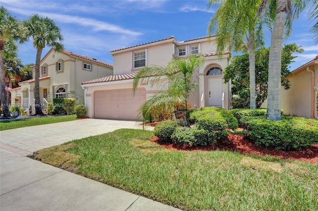 15827 NW 4th Ct, Pembroke Pines, FL 33028 - mediterranean / spanish-style home featuring stucco siding, decorative driveway, a tile roof, and a front lawn