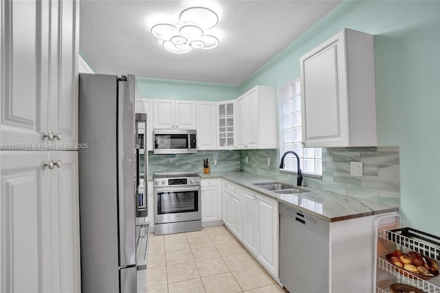 15827 NW 4th Ct, Pembroke Pines, FL 33028 - kitchen featuring stainless steel appliances, white cabinets, tasteful backsplash, light stone counters, and a textured ceiling