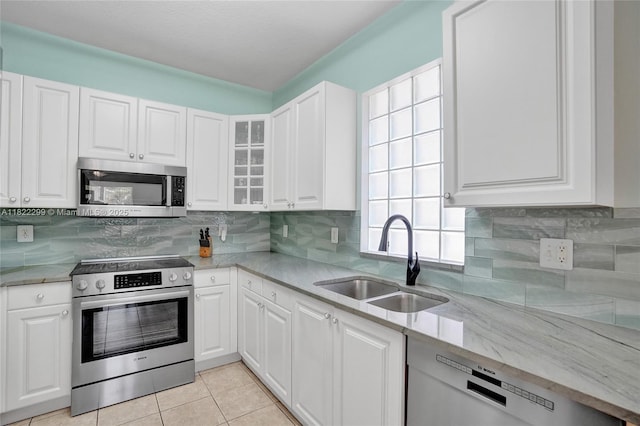 15827 NW 4th Ct, Pembroke Pines, FL 33028 - kitchen with appliances with stainless steel finishes, white cabinetry, light stone countertops, and light tile patterned flooring