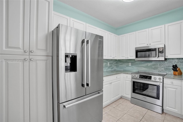 15827 NW 4th Ct, Pembroke Pines, FL 33028 - kitchen with stainless steel appliances, light tile patterned flooring, white cabinets, tasteful backsplash, and light stone countertops