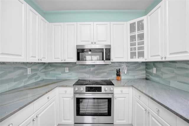 15827 NW 4th Ct, Pembroke Pines, FL 33028 - kitchen with stainless steel appliances, white cabinetry, glass insert cabinets, and decorative backsplash