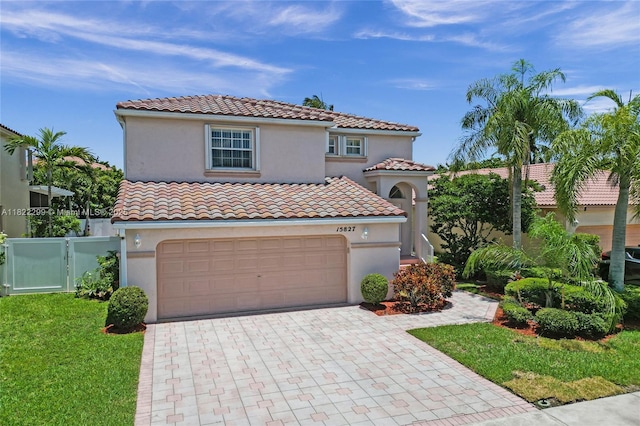15827 NW 4th Ct, Pembroke Pines, FL 33028 - mediterranean / spanish home with a tiled roof, decorative driveway, a garage, stucco siding, and a gate