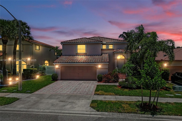 15827 NW 4th Ct, Pembroke Pines, FL 33028 - mediterranean / spanish-style home with a tile roof, driveway, an attached garage, stucco siding, and a lawn
