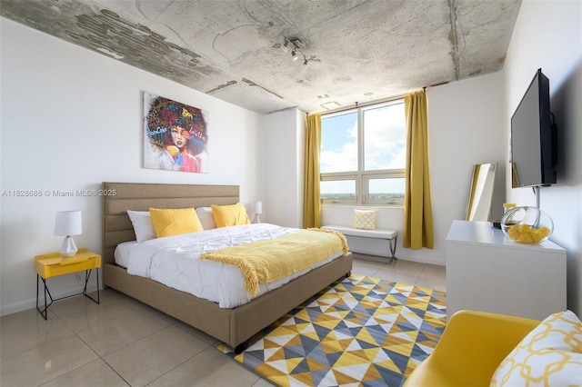 3250 NE 1st Ave Unit 911, Miami, FL 33137 - bedroom featuring light tile patterned floors and baseboards