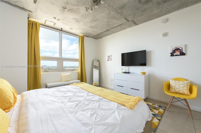 3250 NE 1st Ave Unit 911, Miami, FL 33137 - bedroom featuring baseboards and light tile patterned flooring
