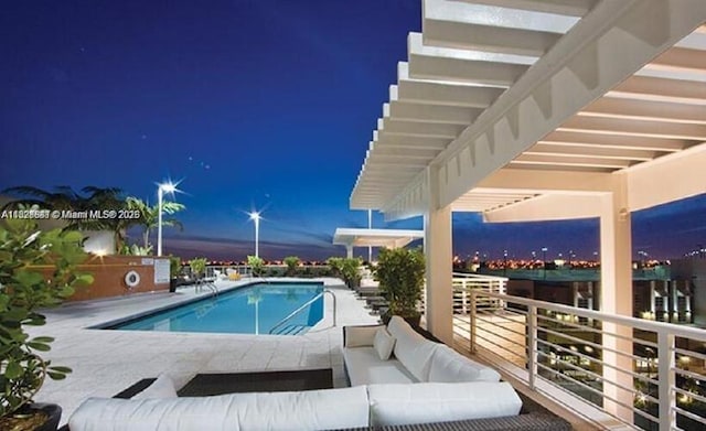 3250 NE 1st Ave Unit 911, Miami, FL 33137 - pool at twilight with outdoor lounge area, a community pool, and a patio