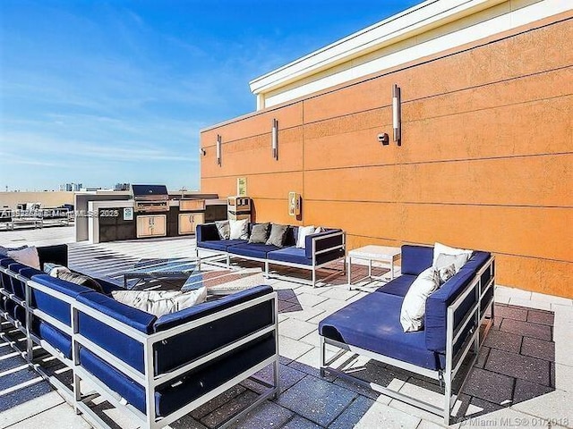 3250 NE 1st Ave Unit 911, Miami, FL 33137 - view of patio with an outdoor living space and exterior kitchen