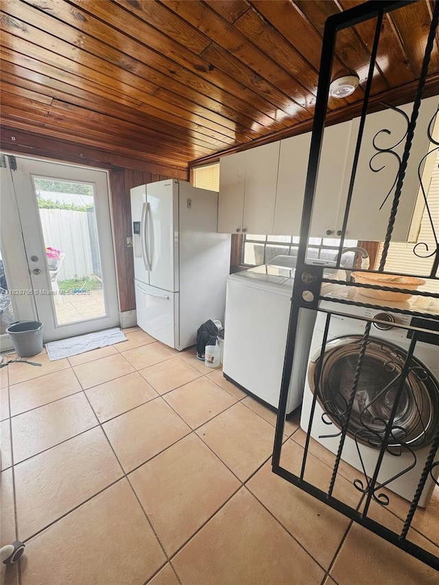3915 NW 4th Ter, Miami, FL 33126 - laundry area with wood ceiling, light tile patterned flooring, and washer / clothes dryer