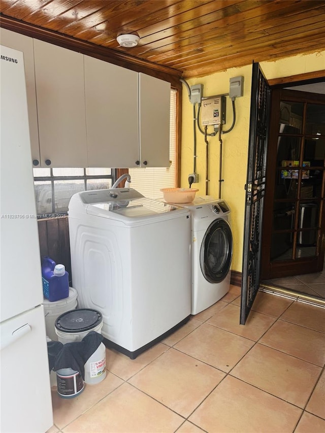 3915 NW 4th Ter, Miami, FL 33126 - laundry room featuring wood ceiling, separate washer and dryer, light tile patterned floors, and cabinet space