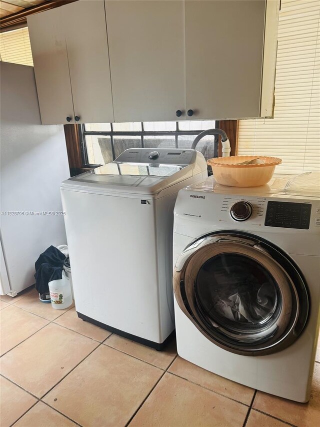 3915 NW 4th Ter, Miami, FL 33126 - laundry room featuring cabinet space, independent washer and dryer, and light tile patterned floors