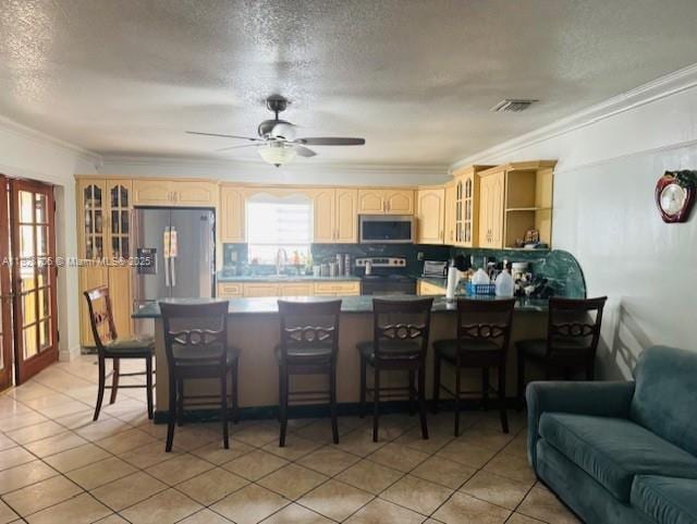 3915 NW 4th Ter, Miami, FL 33126 - kitchen featuring stainless steel appliances, crown molding, a peninsula, glass insert cabinets, and light brown cabinets