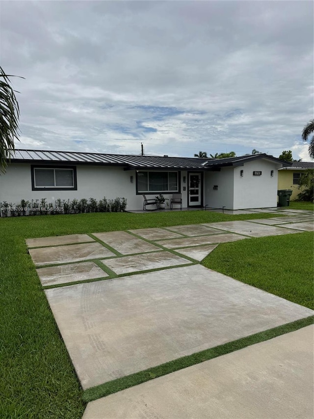8790 NW 15th Ct, Pembroke Pines, FL 33024 - single story home with stucco siding, a front lawn, a standing seam roof, and a metal roof