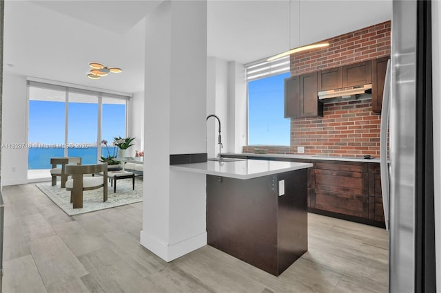 725 NE 22nd St Unit 16A, Miami, FL 33137 - kitchen with freestanding refrigerator, light countertops, healthy amount of natural light, and light wood-type flooring