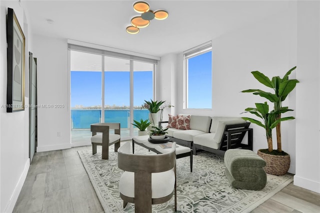 725 NE 22nd St Unit 16A, Miami, FL 33137 - living room featuring light wood-style floors, a water view, and expansive windows
