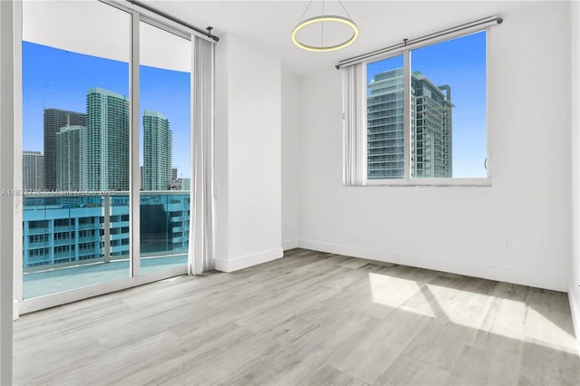 725 NE 22nd St Unit 16A, Miami, FL 33137 - empty room with wood finished floors and baseboards