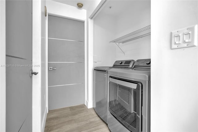 725 NE 22nd St Unit 16A, Miami, FL 33137 - laundry room with washer and clothes dryer and light wood-style flooring