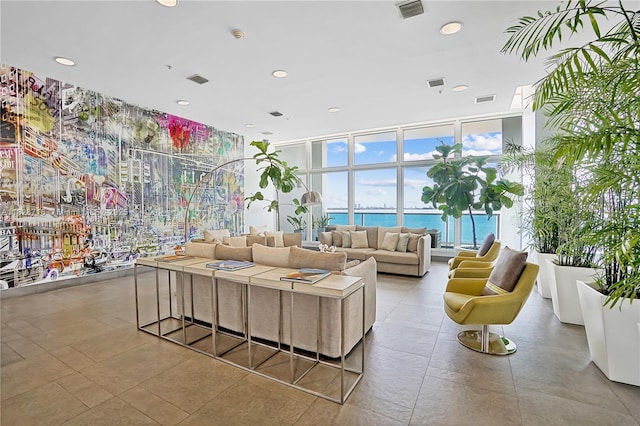 725 NE 22nd St Unit 16A, Miami, FL 33137 - building lobby with a wall of windows, a water view, and recessed lighting