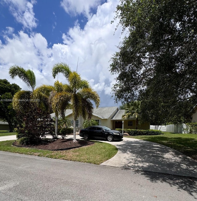 14603 SW 152nd Ct, Miami, FL 33196 - obstructed view of property with concrete driveway and a front yard