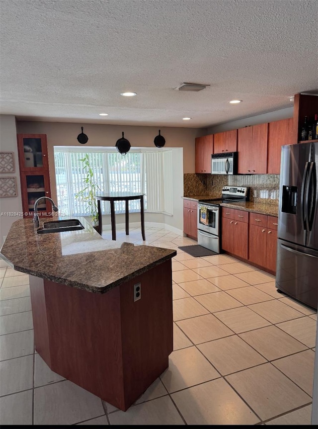 14603 SW 152nd Ct, Miami, FL 33196 - kitchen with appliances with stainless steel finishes, light tile patterned flooring, decorative backsplash, recessed lighting, and brown cabinets