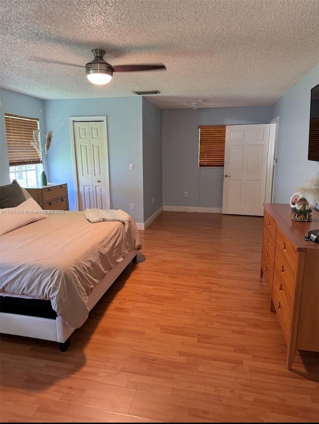 14603 SW 152nd Ct, Miami, FL 33196 - bedroom with light wood finished floors, a ceiling fan, and a textured ceiling