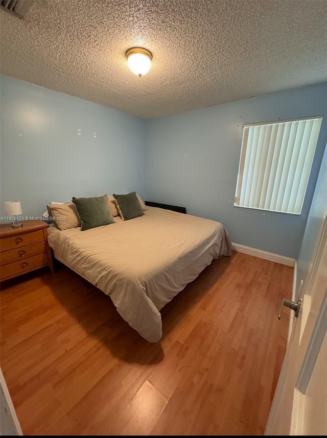 14603 SW 152nd Ct, Miami, FL 33196 - bedroom with wood finished floors and a textured ceiling