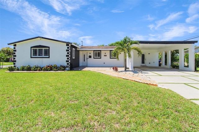 7460 NW 1st Ct, Pembroke Pines, FL 33024 - view of front of house featuring an attached carport, driveway, a front lawn, and stucco siding