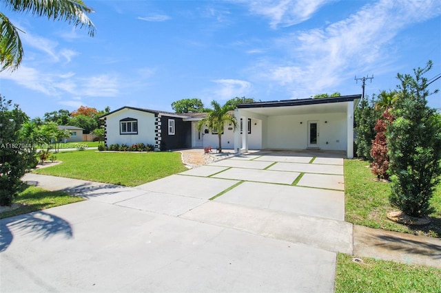 7460 NW 1st Ct, Pembroke Pines, FL 33024 - view of front facade featuring a front lawn, driveway, a carport, and stucco siding