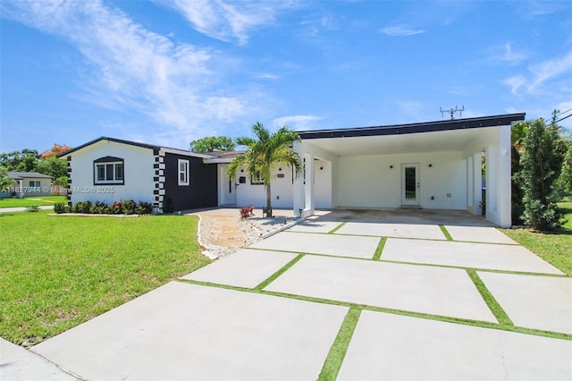 7460 NW 1st Ct, Pembroke Pines, FL 33024 - view of front of home featuring concrete driveway, an attached carport, stucco siding, and a front yard