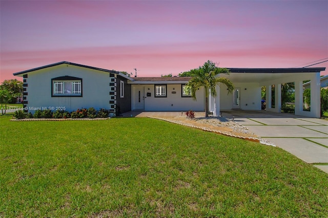 7460 NW 1st Ct, Pembroke Pines, FL 33024 - view of front of home with an attached carport, a front lawn, driveway, and stucco siding