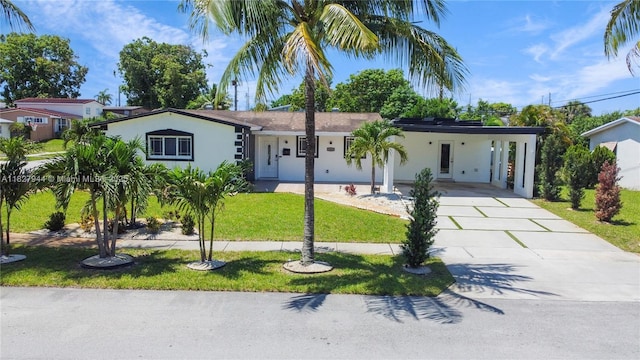 7460 NW 1st Ct, Pembroke Pines, FL 33024 - ranch-style home featuring driveway, a front lawn, a carport, and stucco siding