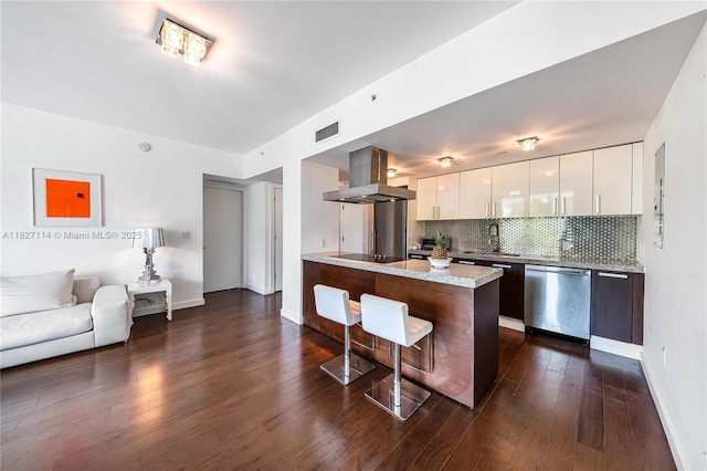 720 NE 62nd St Unit 403, Miami, FL 33138 - kitchen with stainless steel dishwasher, exhaust hood, modern cabinets, a breakfast bar area, and black electric cooktop