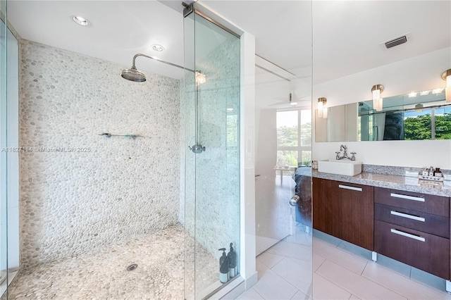 720 NE 62nd St Unit 403, Miami, FL 33138 - bathroom featuring tiled shower, vanity, and tile patterned floors