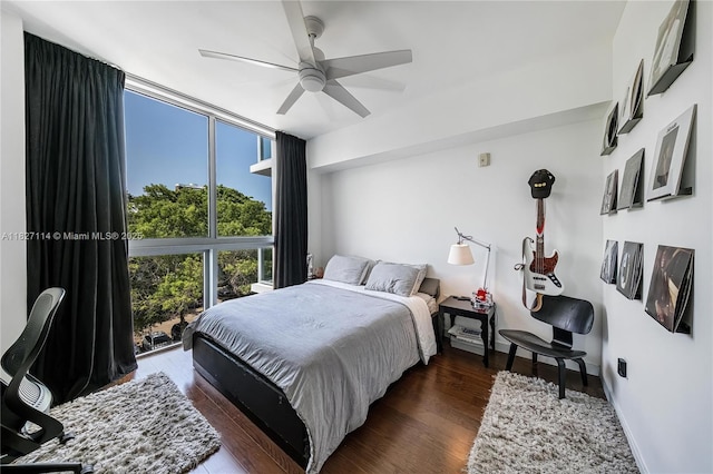 720 NE 62nd St Unit 403, Miami, FL 33138 - bedroom featuring dark wood-style flooring, ceiling fan, and expansive windows