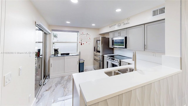 889 Hamilton Dr Unit 889B, Homestead, FL 33034 - kitchen featuring appliances with stainless steel finishes, light marble finish flooring, recessed lighting, gray cabinetry, and light countertops