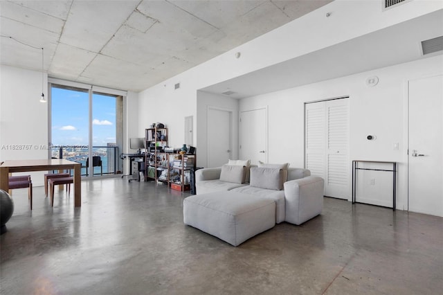 151 SE 1st St Unit 3102, Miami, FL 33131 - living room featuring a wall of windows and concrete floors