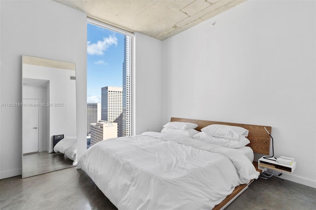 151 SE 1st St Unit 3102, Miami, FL 33131 - bedroom featuring finished concrete flooring, expansive windows, and a city view